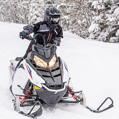 POLARIS<sup>&reg;</sup> RMK EVO Snowmobile - Enjoy this snowmobile which is designed with compact ergonomics to accommodate a wide range of riders.  Features include optimized seating position, easy to reach throttle, suspension engineered for a stable and effortless ride, adjustable-stance Independent Front Suspension, and speed electronically limited to 50 mph.