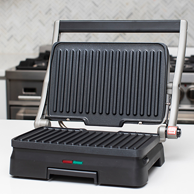 CUISINART<sup>&reg;</sup> Griddler<sup>&reg;</sup> Grill & Panini Press - Grill burgers, press sandwiches and more with this compact and convenient addition to your countertop.  Features removable nonstick plates which can open flat to double the cooking surface, adjustable front feet, drip tray, and preset temperature with ready to cook indicator lights.  Plates and drip tray are dishwasher safe.